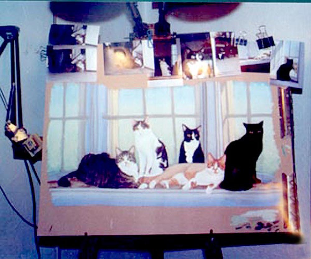 portrait of cats on easel.