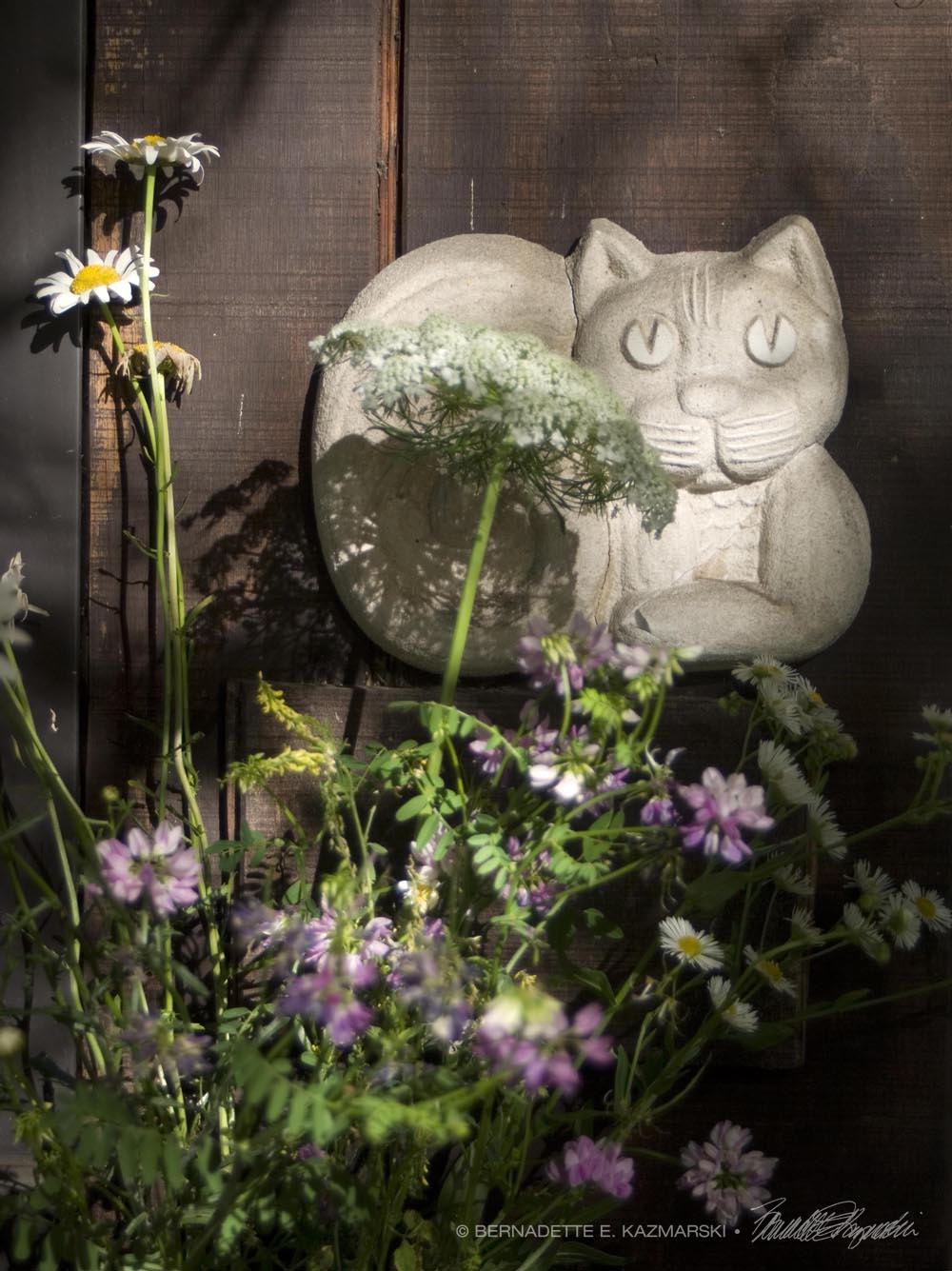 cat sculpture with flowers