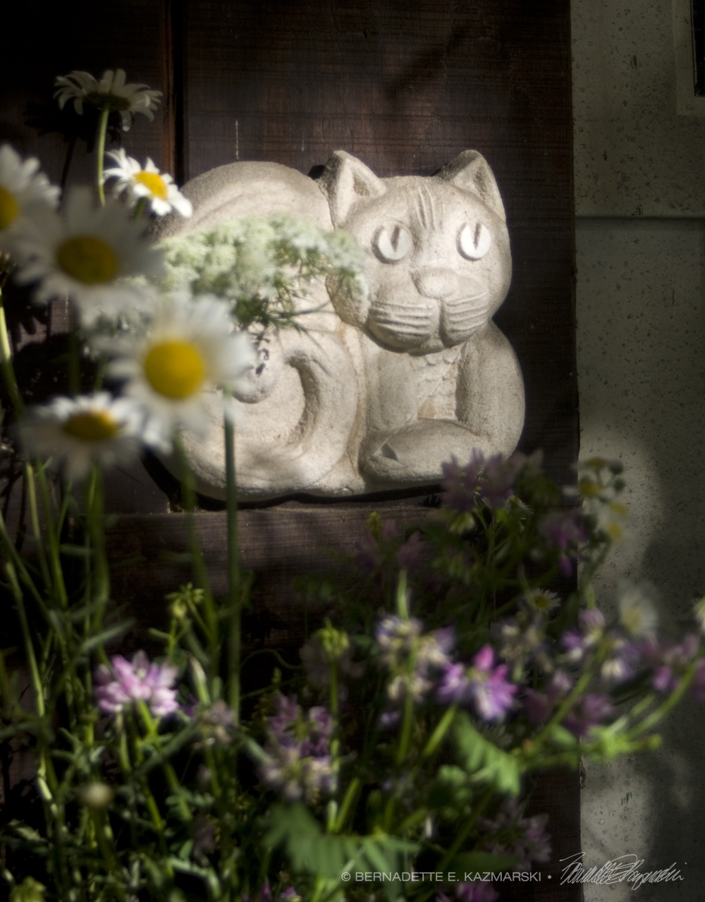 cat sculpture and flowers