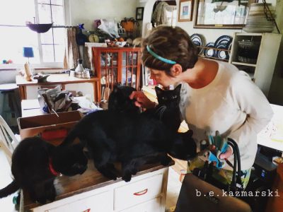 woman greeting black cats