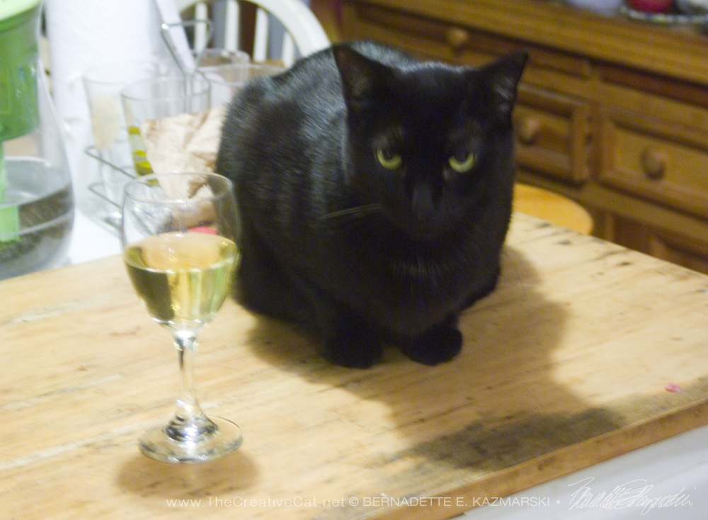 black cat with glass of wine