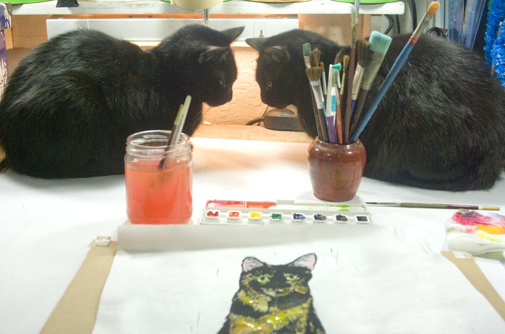 two black cats with painting