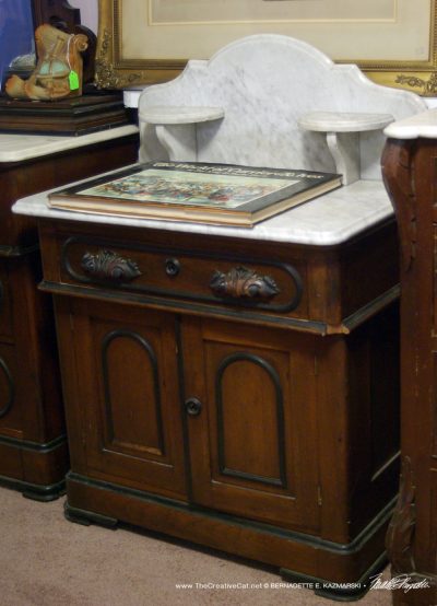 The marble-topped dressing table.