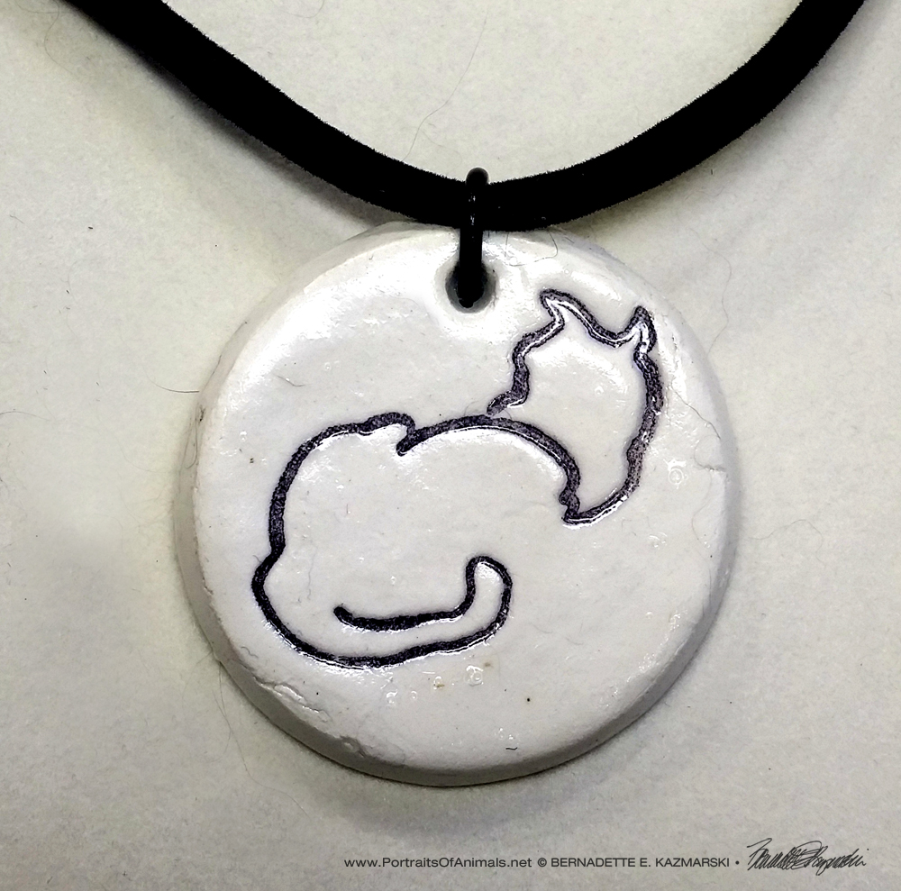 "Back to Front" pendant, 1" x 1" round on flocked cord.