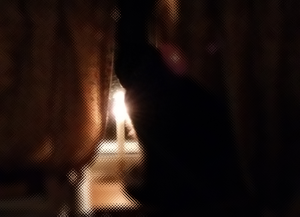 black cat at window with candle